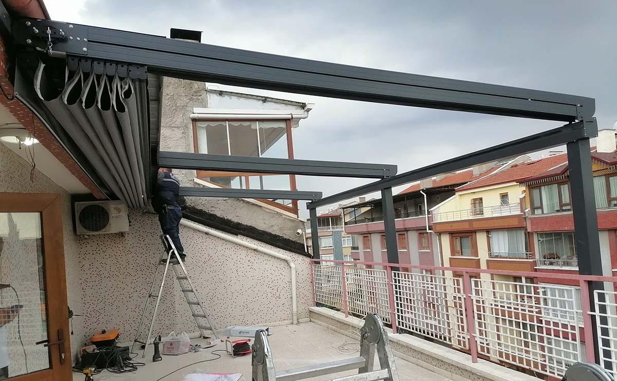 Worker installing retractable awning system